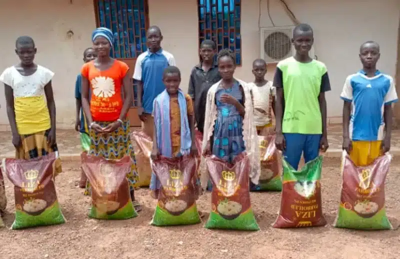 Displaced students receiving bags of rice